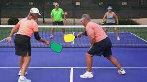 Pickleball doubles game with players mastering teamwork and tactics.