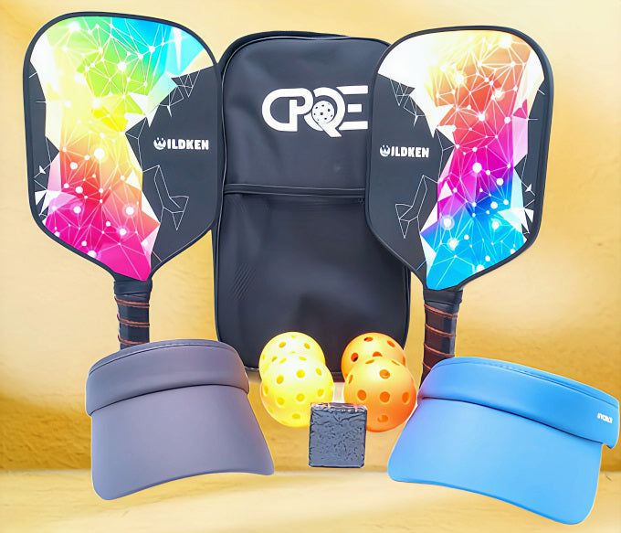 Complete set of USAPA-approved pickleball paddles with colorful design, pickleballs, carry bag, visors, and paddle eraser.