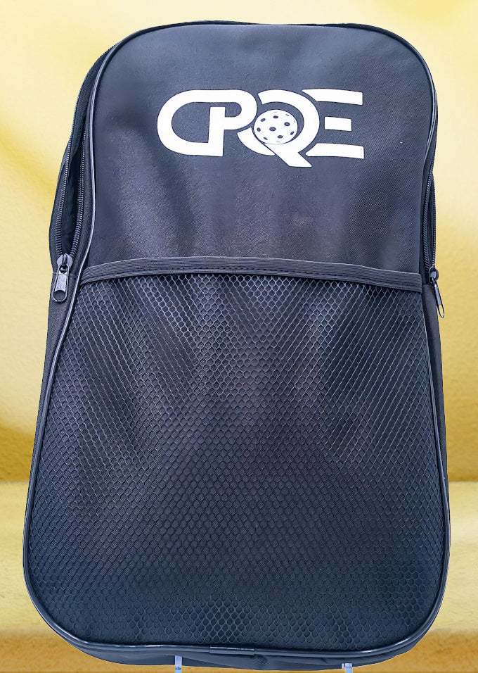 Black CPQE nylon pickleball bag with zippered compartments and mesh pocket.