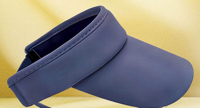 Pickleball visor on yellow background, adjustable strap, breathable fabric.