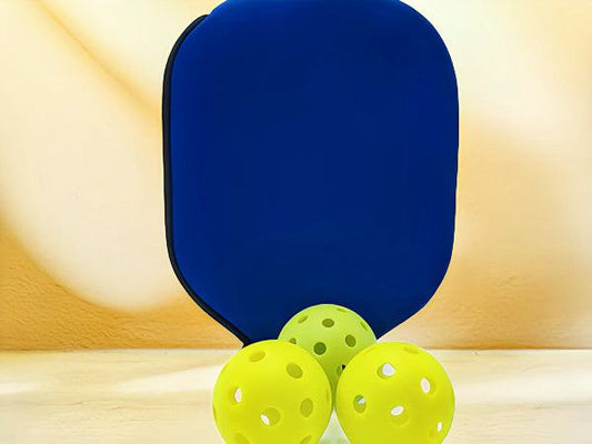 Pickleball paddle covers with three yellow pickleball balls.